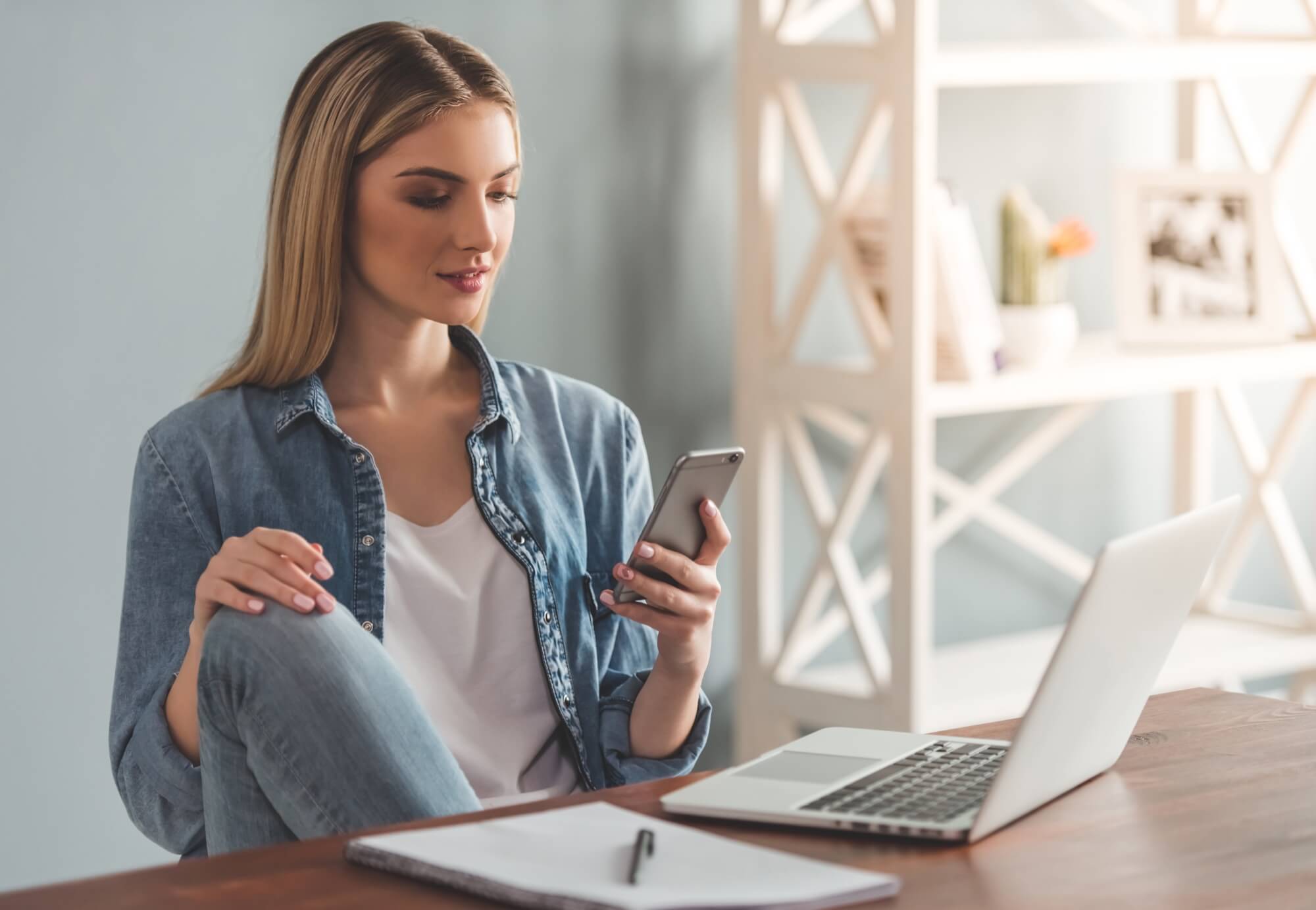 Woman take a home business with smartphone and laptop
